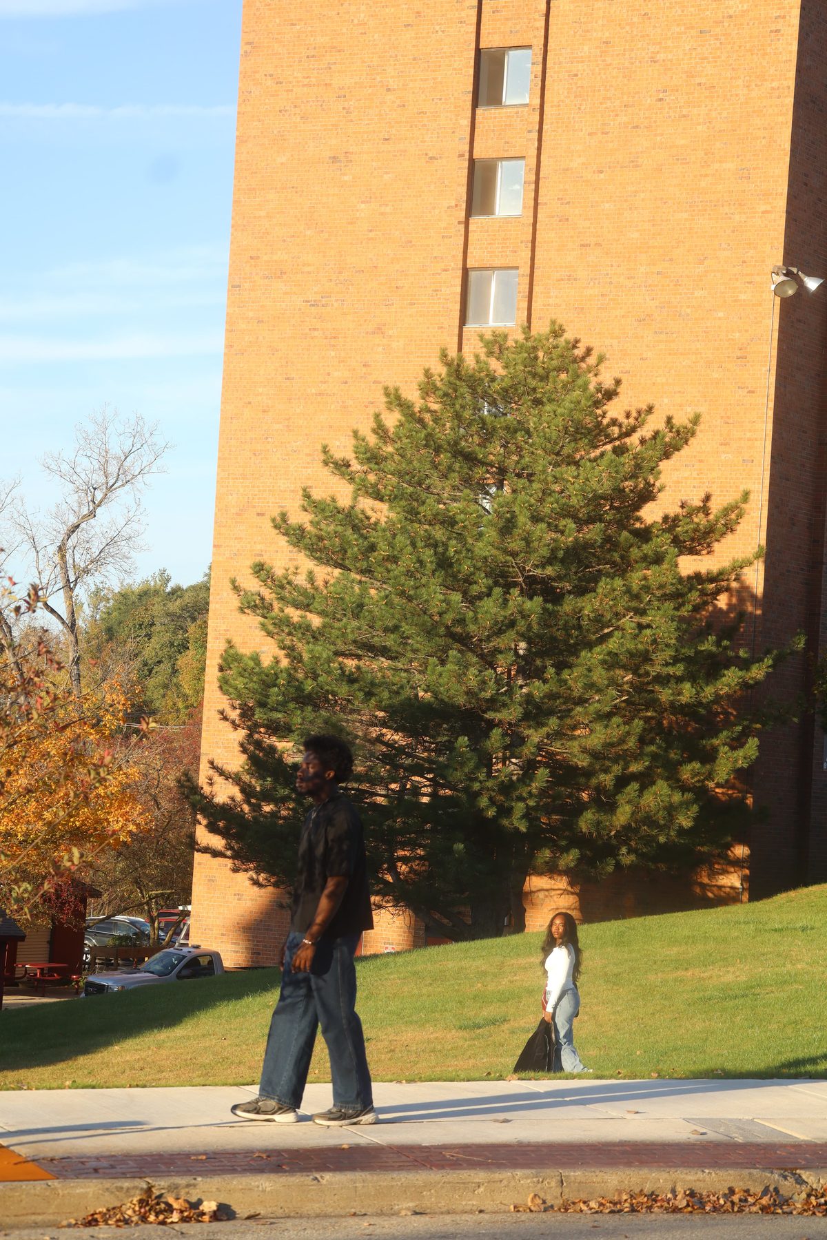 Staged Still, the man walking on, the woman on the grass looking back