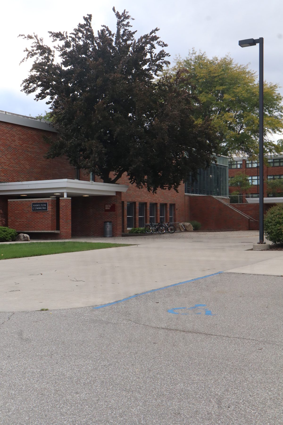 Hamilton Commons, a brick building with an accessible parking mark in front